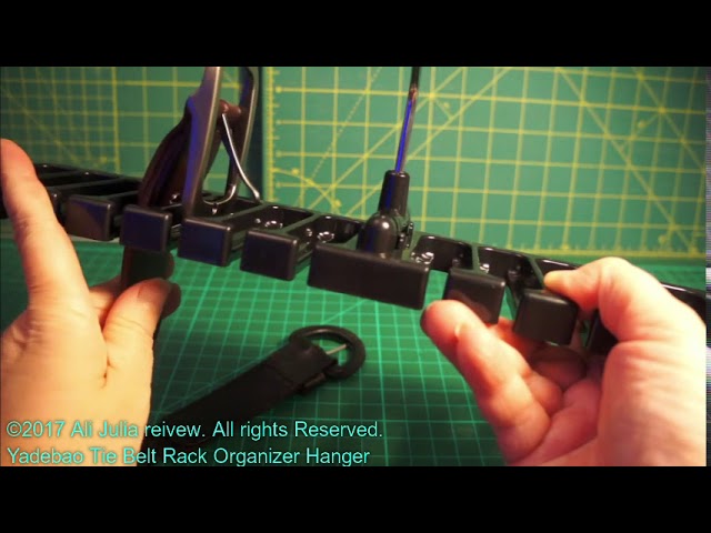 The hanger is made out of thick plastic, you slide the belt from the side and the belt buckle is too thick to fall through the slot